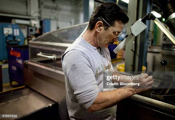 Don Daldo inspects a 2010 Sacagawea dollar coin at the United States Mint in Philadelphia, Pennsylvania, U.S., on Thursday, Feb. 25, 2010. The U.S....