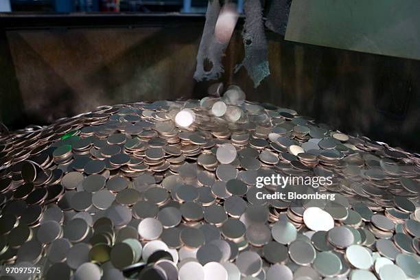 Ten cent blanks fill a bin prior to being struck at the United States Mint in Philadelphia, Pennsylvania, U.S., on Thursday, Feb. 25, 2010. The U.S....