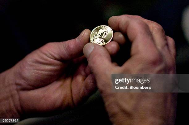 Don Daldo inspects a 2010 Sacagawea dollar coin at the United States Mint in Philadelphia, Pennsylvania, U.S., on Thursday, Feb. 25, 2010. The U.S....