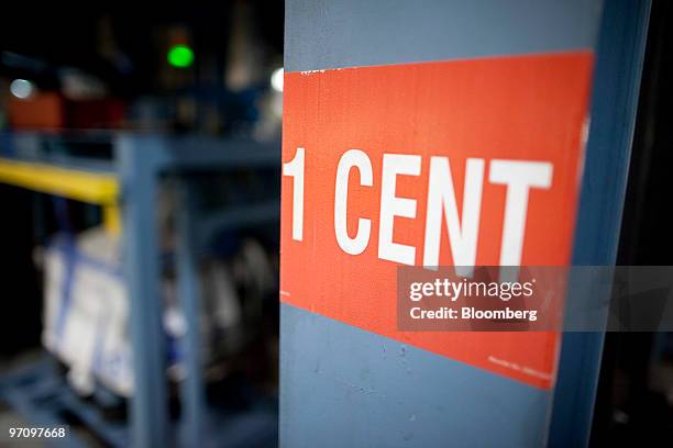 One cent sign is placed on the side of a striking machine at the United States Mint in Philadelphia, Pennsylvania, U.S., on Thursday, Feb. 25, 2010....