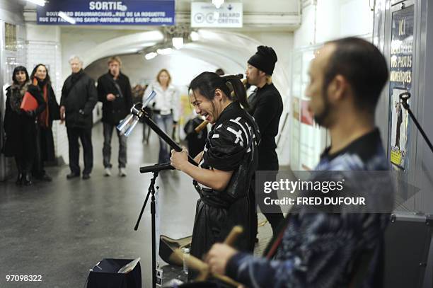 Japanese Tsugaru Shamisen player Keisho Ohno performs in Paris' subway on February 26 to promote this northern Japan traditional music. AFP PHOTO /...