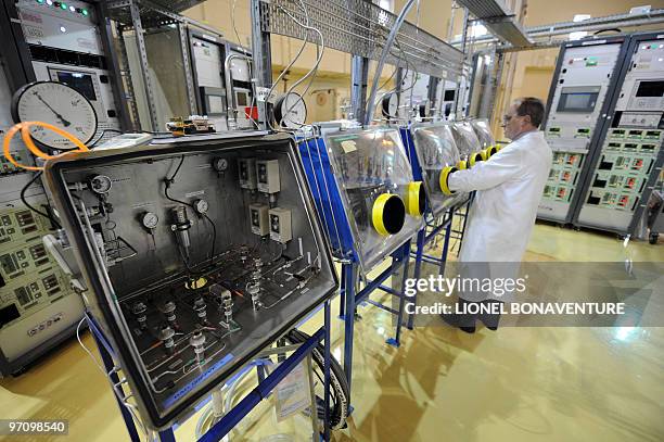 An employee of French Atomic Energy Commission works at a handling post in the Osiris reactor hall on February 24, 2010 at the CEA center in Saclay,...