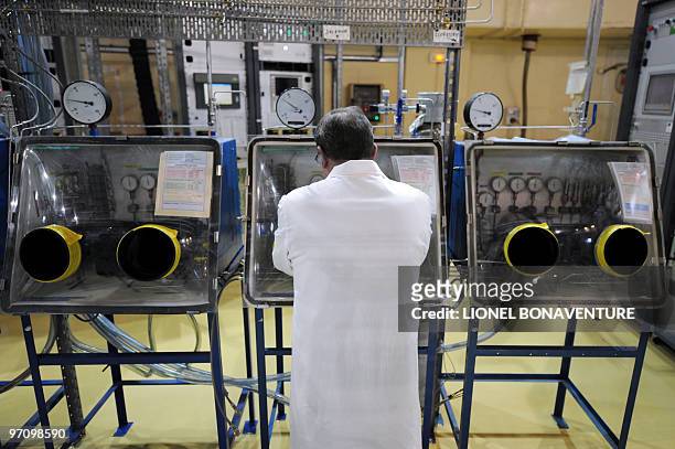 An employee of French Atomic Energy Commission works at a handling post in the Osiris reactor hall on February 24, 2010 at the CEA center in Saclay,...