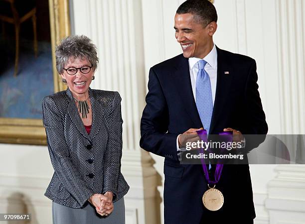 President Barack Obama, right, holds a National Medal of Arts before presenting it to Rita Moreno, an actor, singer and dancer, during a ceremony in...