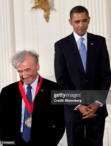 Writer and Holocaust survivor Elie Wiesel, left, walks offstage after receiving the National Humanities Medal from U.S. President Barack Obama during...