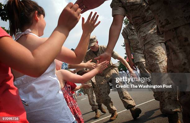 Lima Company gets high-fives and cheers during a Memorial Day Parade. They say they were surprised by the amount of support they received from their...