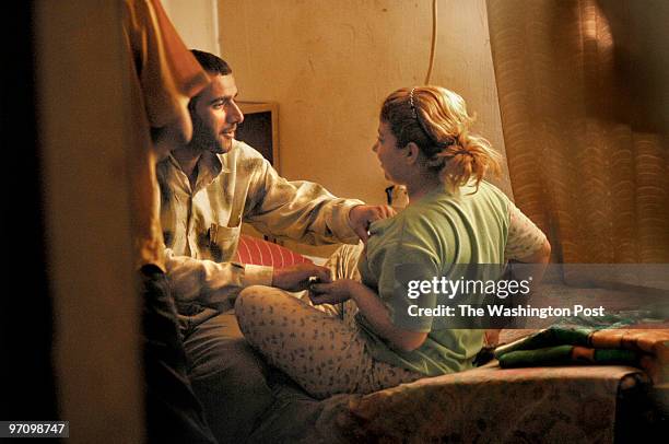 Halla Muhammed Maarouf bargins with a customer in her mother's home, where she and her two sons also lived for several months following the war....