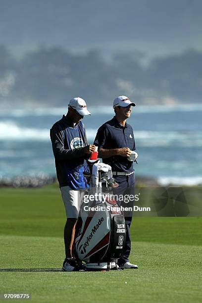 Dustin Johnson waits to hit his second shot on the 18th hole during the final round of the AT&T Pebble Beach National Pro-Am at Pebble Beach Golf...