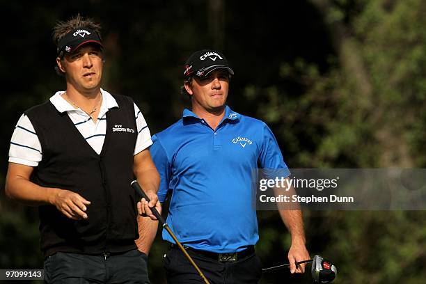 Fredrik Jacobson and Nicholas Thompson walk during the first round of the Northern Trust Open at Riveria Country Club on February 4, 2010 in Pacific...