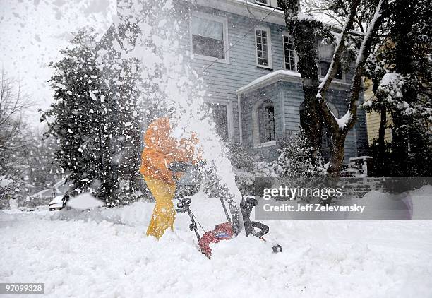 Resident uses a snowblower to clear his driveway on February 26, 2010 in Maplewood, New Jersey. Over a foot of powdery, drifting snow fell overnight,...