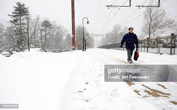 Commuter walks to the NJ Transit train station on February 26, 2010 in Maplewood, New Jersey. Over a foot of powdery, drifting snow fell overnight,...