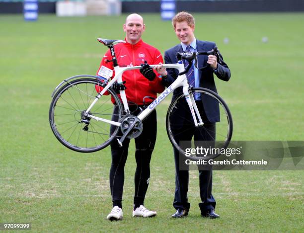 Prince Harry poses with former England rugby international Lawrence Dallaglio after Dallaglio and other cyclists taking part in the Dallaglio Cycle...