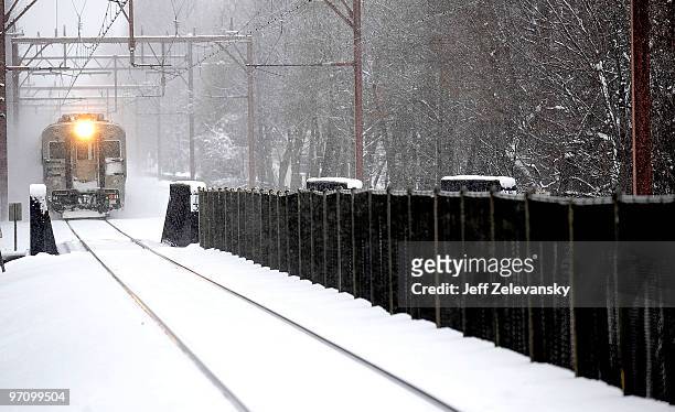 An NJ Transit Midtown Direct train travels slowly into the station February 26, 2010 in Maplewood, New Jersey. Over a foot of powdery, drifting snow...