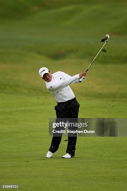 Andres Romero of Argentina hits his second shot on the eighth hole during the continuation of the second round of the Northern Trust Open at Riviera...