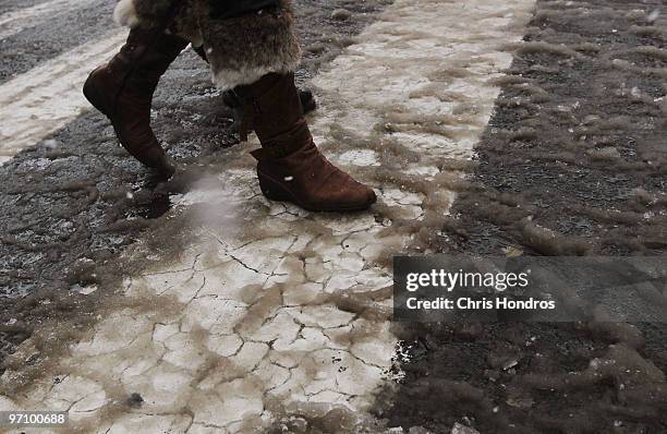 Woman walks in the slush of a crosswalk near Union Square in Manhattan February 26, 2010 in New York City. A massive snowstorm rocked New York City...
