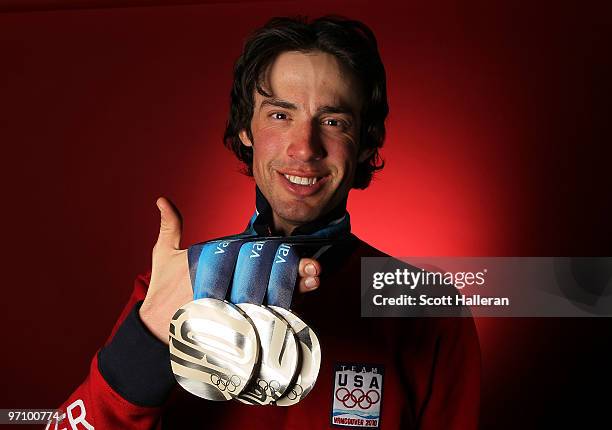 Nordic combined skier Johnny Spillane of the United States poses with his silver medals for the cross-country individual NH/10 km, the cross-country...