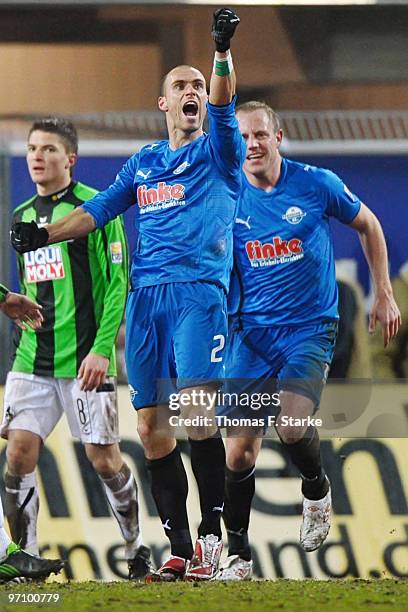 Daniel Brueckner of Paderborn celebrates scoring his team's second goal while Frank Loening of Paderborn and Aleksandar Ignjovski of Munich look on...