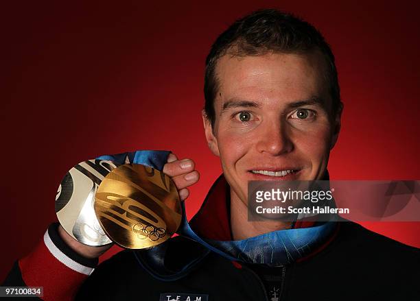 Nordic combined skier Bill Demong of the United States poses with his gold medal for the cross-country individual LH/10 km and silver medal for the...