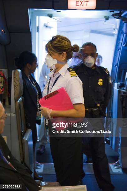 Centers for Disease Control quarantine officer Danitza Tomianovic entering a plane in order to assess the status of an ill traveler, Miami...