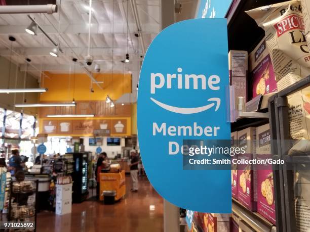 At a Whole Foods Market grocery store in San Ramon, California, signage advertises new discounts for members of the Amazon Prime service from Amazon,...
