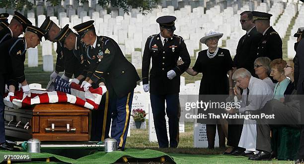 Arlington Cemetery, VA Keith Wallace, at right, in white shirt, wipes away a tear during funeral services for his son Cpl. Matthew P. Wallace at...