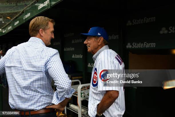 Hall of Fame football player Joe Namath is talks with Chicago Cubs President Crane Kenney before the game between the Chicago Cubs and the...