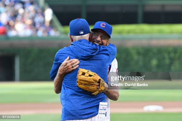Hall of Fame football player Joe Namath gets a hug from Joe Maddon of the Chicago Cubs after throwing out a ceremonial first pitch before the game...