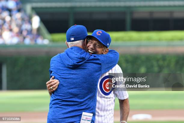 Hall of Fame football player Joe Namath gets a hug from Joe Maddon of the Chicago Cubs after throwing out a ceremonial first pitch before the game...