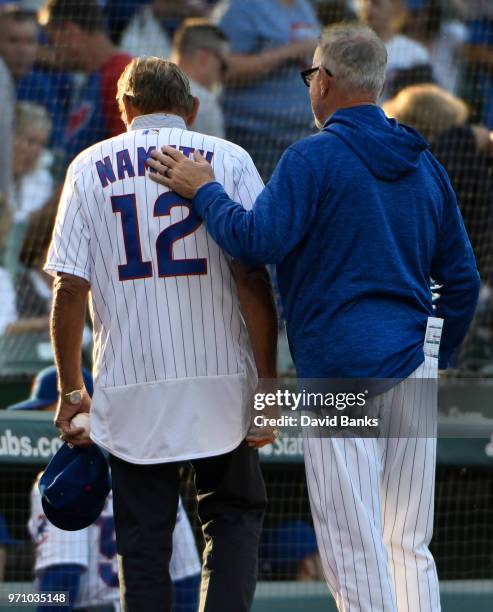 Hall of Fame football player Joe Namath and Joe Maddon of the Chicago Cubs walk off the field after the national anthem before the game between the...