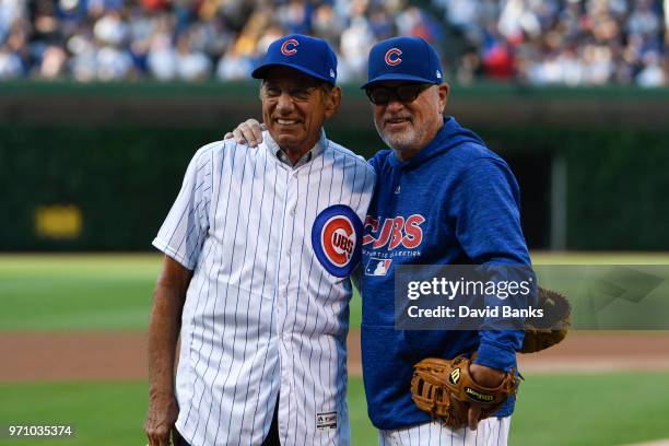 Hall of Fame football player Joe Namath and Joe Maddon of the Chicago Cubs after throwing out a ceremonial first pitch before the game between the...