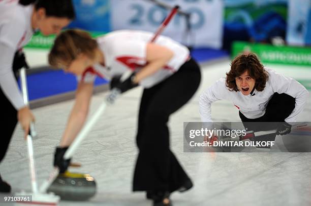 Switzerland's Mirjam Ott shouts as she delivers the stone during the bronze medal match against China in the Vancouver Winter Olympics women's...