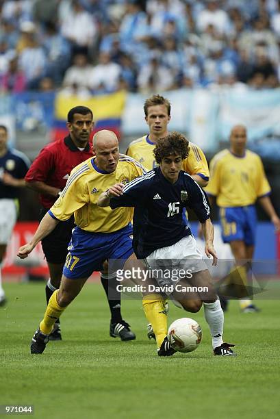 Pablo Aimar of Argentina is challenged by Magnus Svensson of Sweden during the Argentina v Sweden, Group F, World Cup Group Stage match played at the...