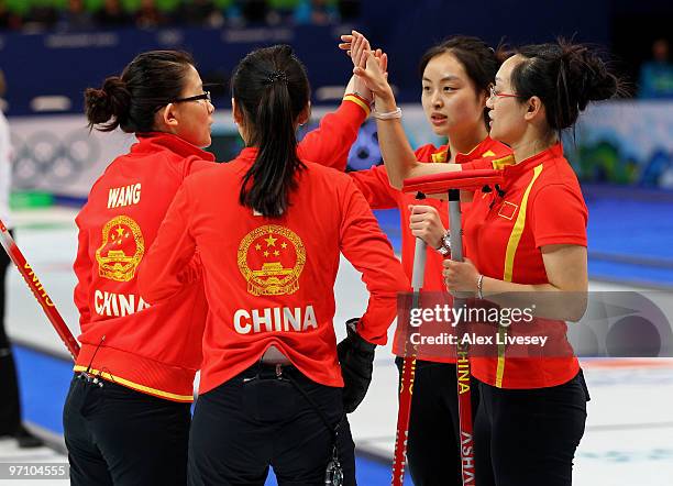 Bingyu Wang, Yin Liu, Qingshuang Yue and Yan Zhou of China celebrate winning an end during the women's bronze medal curling game between China and...