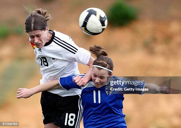 Kerstin Garefrekes of Germany and Susanna Lehtinen of Finland battle for the ball during the Woman's Algarve Cup match between Germany and Finland at...