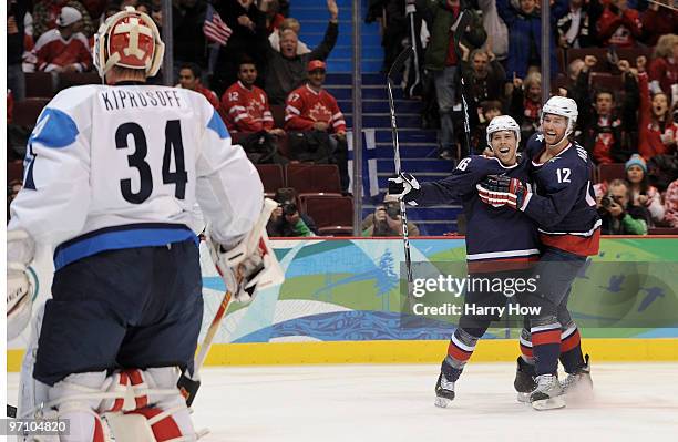 Ryan Malone of the United States celebrates with his team mate Joe Pavelski after Malone scored past goalkeeper Miikka Kiprusoff of Finland during...