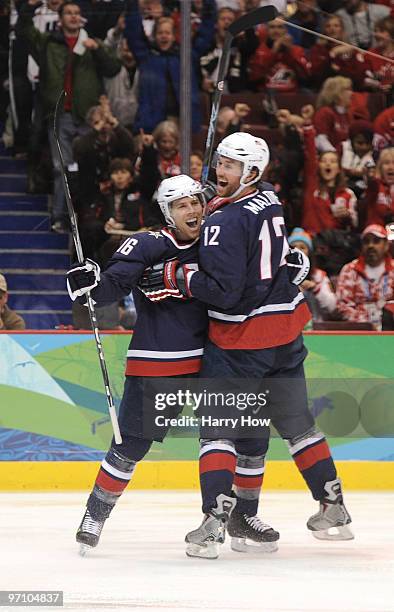 Ryan Malone of the United States celebrates with his team mate Joe Pavelski after Malone scored past goalkeeper Miikka Kiprusoff of Finland during...