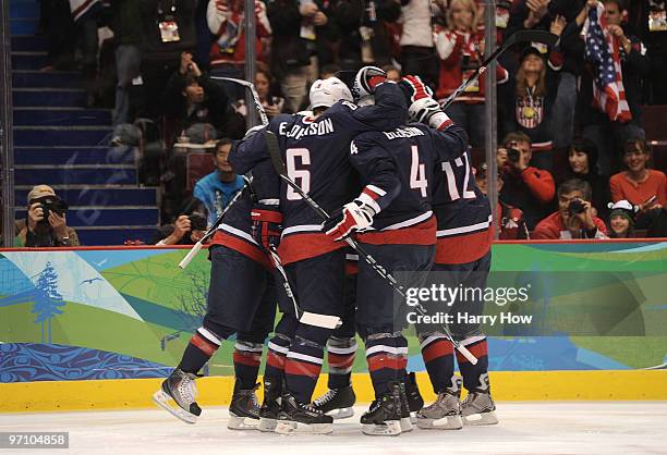 Ryan Malone of the United States celebrates with his team mates after he scored past goalkeeper Miikka Kiprusoff of Finland during the ice hockey...