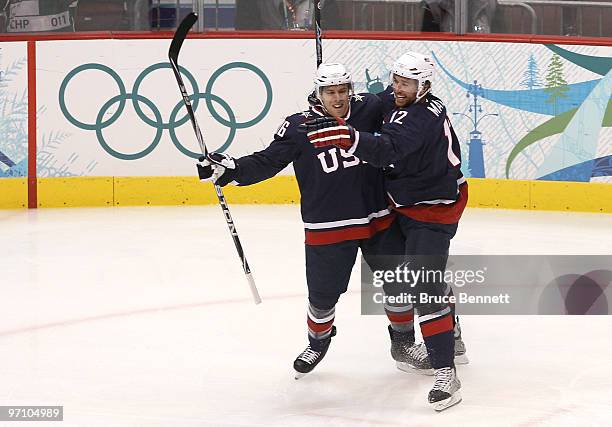 Ryan Malone of the United States celebrates with his team mate Joe Pavelski after Malone scored past goalkeeper Miikka Kiprusoff of Finland during...