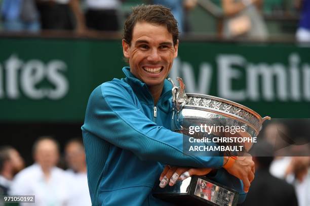 Spain's Rafael Nadal poses with the Mousquetaires Cup after his victory in the men's singles final match against Austria's Dominic Thiem, on day...