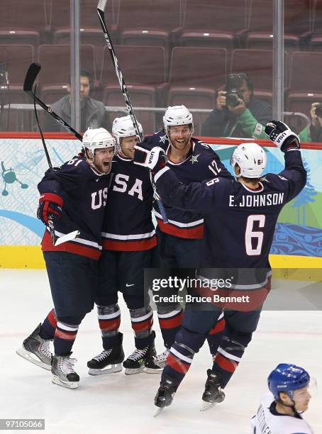 Ryan Malone of the United States celebrates with his team mates after he scored past goalkeeper Miikka Kiprusoff of Finland during the ice hockey...