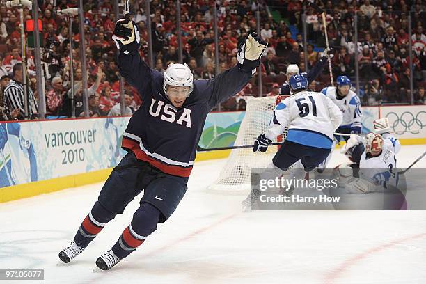 Zach Parise of the United States celebrating scoring past goalkeeper Miikka Kiprusoff of Finland during the ice hockey men's semifinal game between...