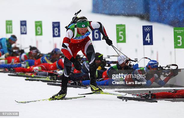 Simon Eder of Austria skis past the shooting range during the men's 4 x 7.5 km biathlon relay on day 15 of the 2010 Vancouver Winter Olympics at...