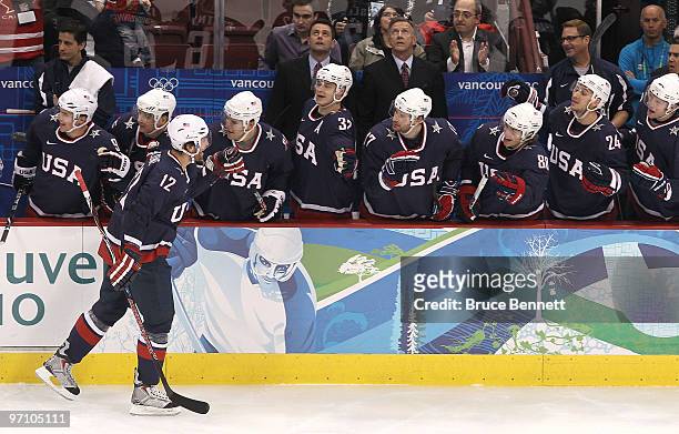 Ryan Malone of the United States celebrates with his team mates after he scored past goalkeeper Miikka Kiprusoff of Finland during the ice hockey...