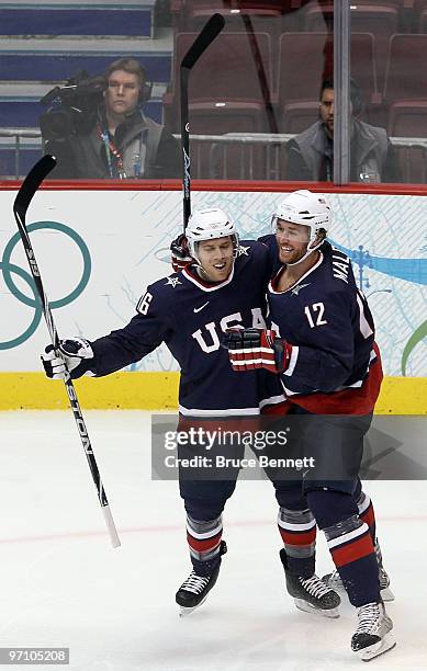 Ryan Malone of the United States celebrates with his team mate Joe Pavelski after Malone scored past goalkeeper Miikka Kiprusoff of Finland during...