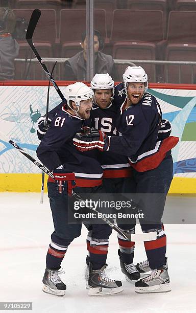 Ryan Malone of the United States celebrates with his team mates after he scored past goalkeeper Miikka Kiprusoff of Finland during the ice hockey...