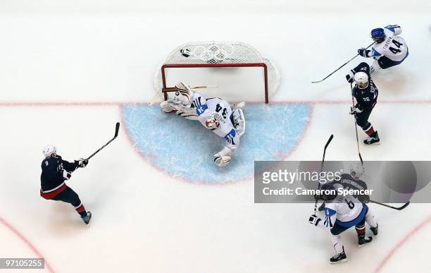 Zach Parise of the United States scores past goalkeeper Miikka Kiprusoff of Finland during the ice hockey men's semifinal game between the United...
