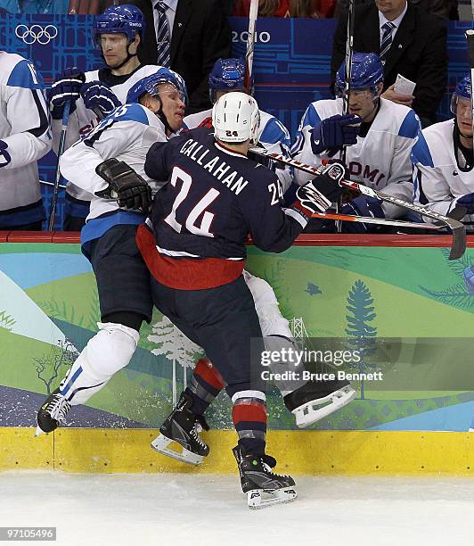 Ryan Callahan of the United States checks Tuomo Ruutu of Finland into his own bench during the ice hockey men's semifinal game between the United...