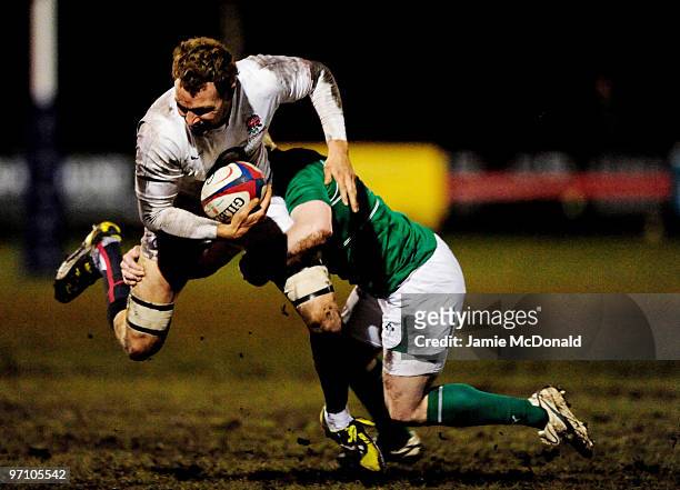 Tom Powell of English Counties is tackled by Eric Maloney of Irish Clubs during the English Counties v Irish Clubs match at Stourton Park on February...