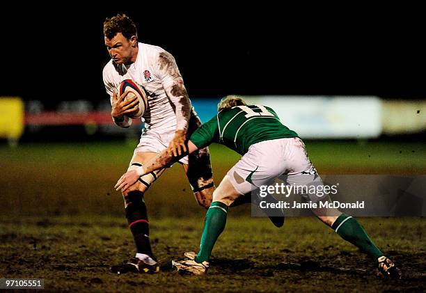 Tom Powell of English Counties is tackled by Eric Maloney of Irish Clubs during the English Counties v Irish Clubs match at Stourton Park on February...