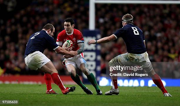 Stephen Jones of Wales takes on William Servat and Imanol Harinordoquy of France during the RBS Six Nations match between Wales and France at the...